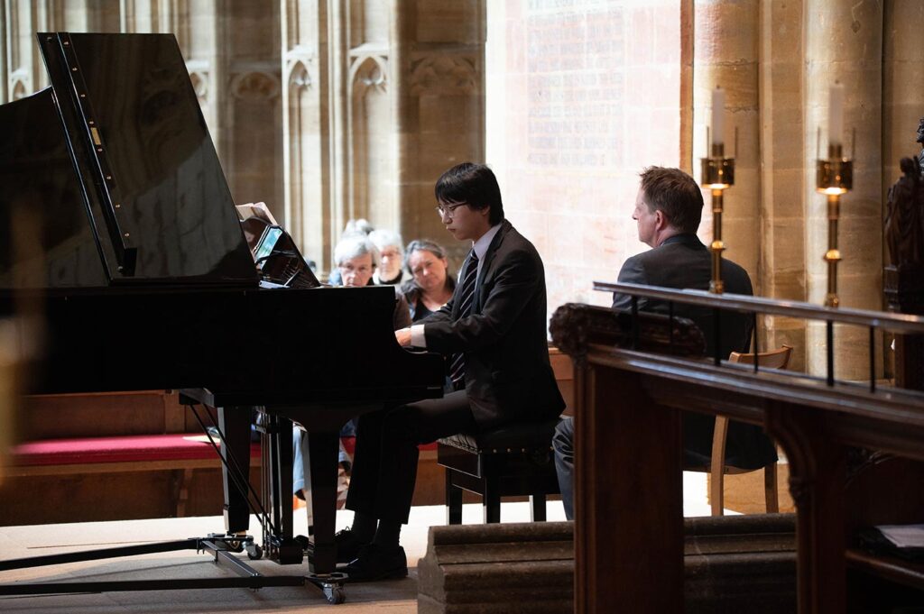 Sherborne School Chamber Concert - boy playing new piano in Abbey