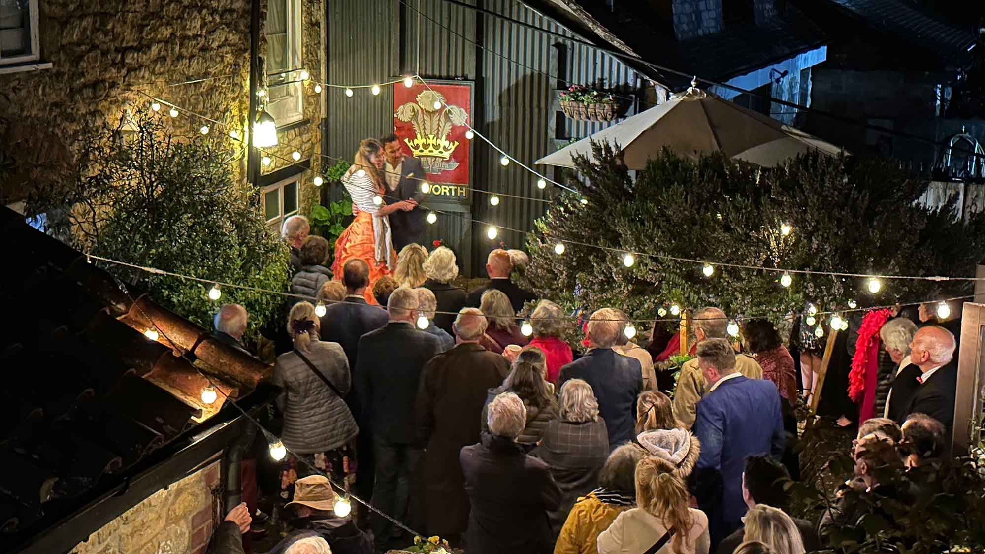 Opera singers with a large crowd at plume of feathers